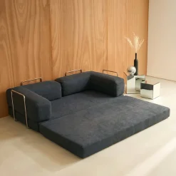 Divano letto futon in velluto a coste e struttura cromata